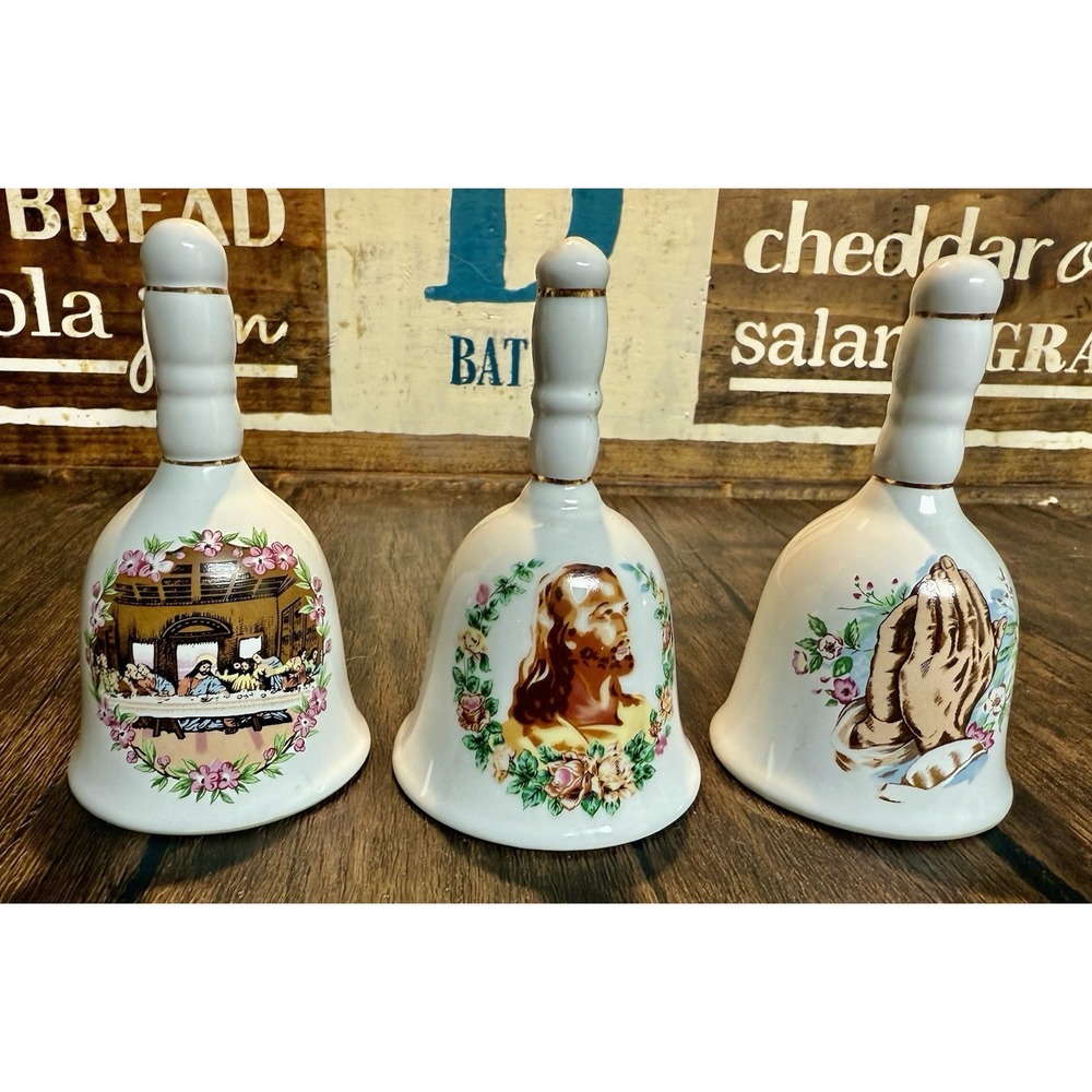 Set of three Vintage decorative porcelain bells with religious imagery.